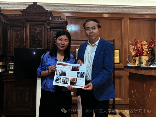 图二 袁熙坤先生将亲笔签名的《联合国首授“环保艺术大师”袁熙坤》赠送给周敏教授